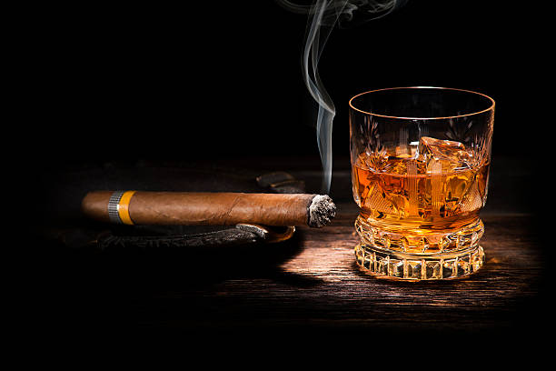Whiskey and cigar Whiskey and cigar on wooden background close up cigar photos stock pictures, royalty-free photos & images