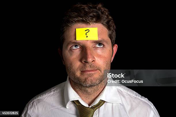 Man With Yellow Postit Note On His Forehead Stock Photo - Download Image Now - Adhesive Note, Adult, Adults Only