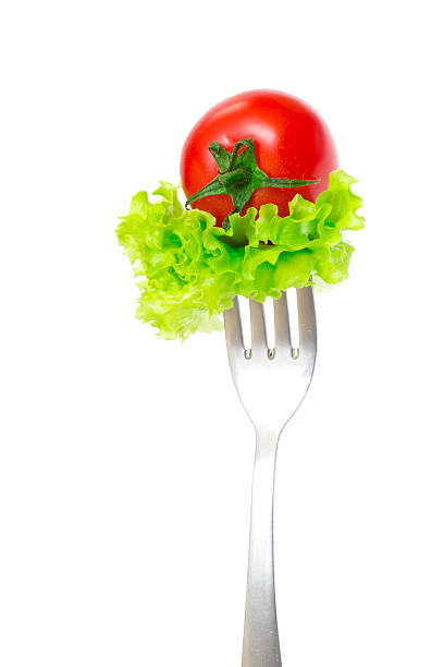 ciliegia fresca pomodoro sulla forcella isolato su sfondo bianco - healthy eating green studio shot vertical foto e immagini stock
