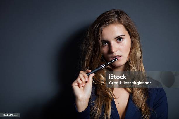 Elegant Woman With Ecigarette Wearing Suit Stock Photo - Download Image Now - Addiction, Adult, Adults Only