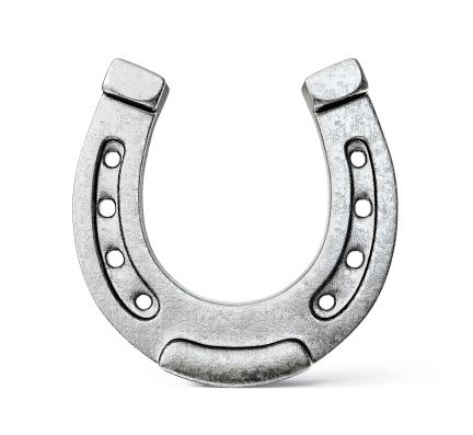 Silver colored horseshoe on a white background