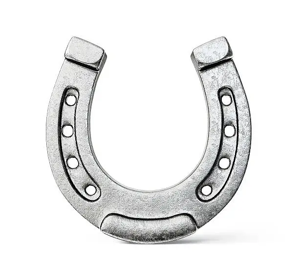 Photo of Silver colored horseshoe on a white background
