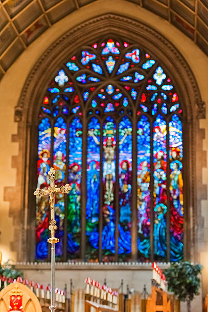 istock Crucifix in front of a stained glass window 453518015