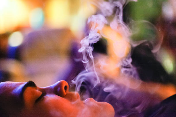 istock Woman Exhales Smoke From a E-Cigarette 453521627