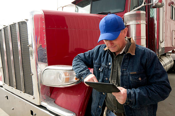 Truck Driver and Tablet PC stock photo