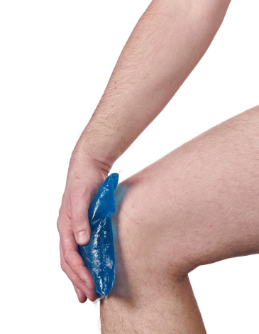 Cool gel pack on a swollen hurting knee. Male holding hand to spot of neck-aches.