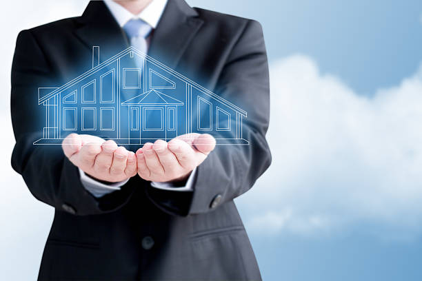 istock Businessman  Holding Virtual  House 453524567