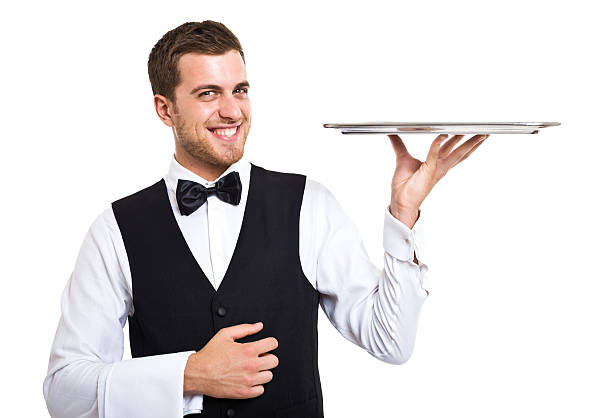 Smiling waiter portrait Smiling waiter holding an empty metal plate waiter stock pictures, royalty-free photos & images