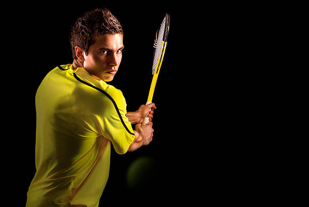 Tennis Player Backhand Portrait A young male tennis player hitting backhand. tennis outfit stock pictures, royalty-free photos & images