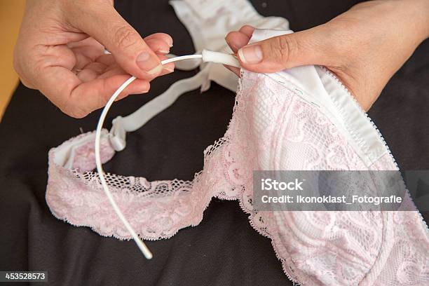 Woman Sewing Ribbon And Rose To Lingerie Stock Photo - Download Image Now - Bra, Wire, Lingerie