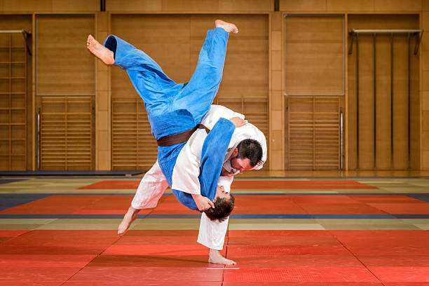 istock Judokas fighting, one in white, one in blue 453529881