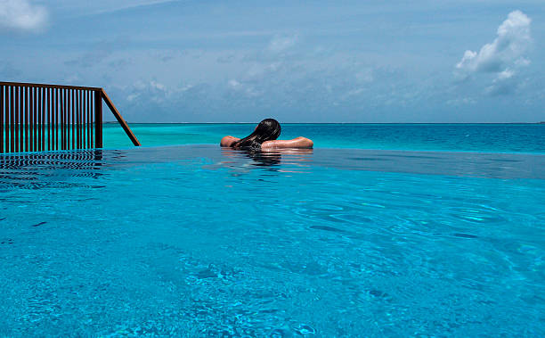 istock girl relaxing in seaside pool 453531677