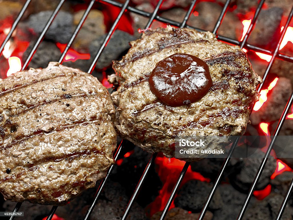 Hamburger Steak Juicy Hamburger Steak with bbq sauce on BBQ Grill. Appetizer Stock Photo