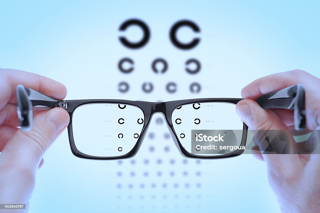 Checking vision on the table Golovin. Checking vision on the table Golovin. In the blue shadows. Eyeglasses Stock Photo