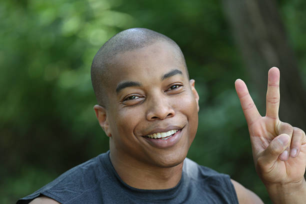 istock young man and peace sign 453542547
