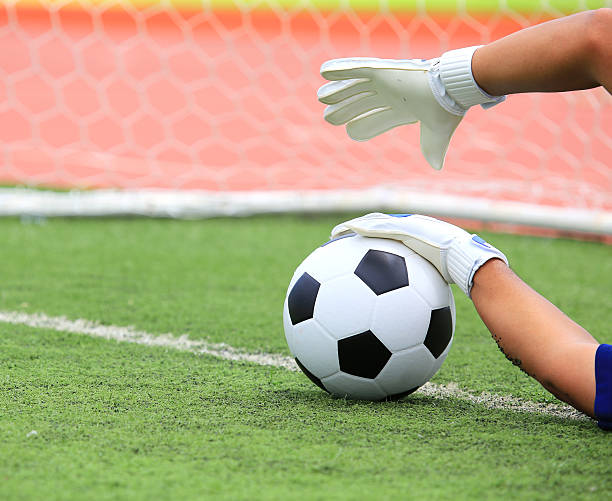 istock Soccer goalkeeper's hands reaching for the ball 453552437