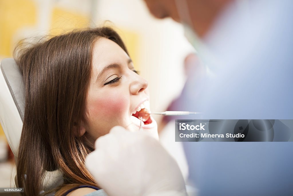 Facendo un trattamento dentale dentista - Foto stock royalty-free di Adulto