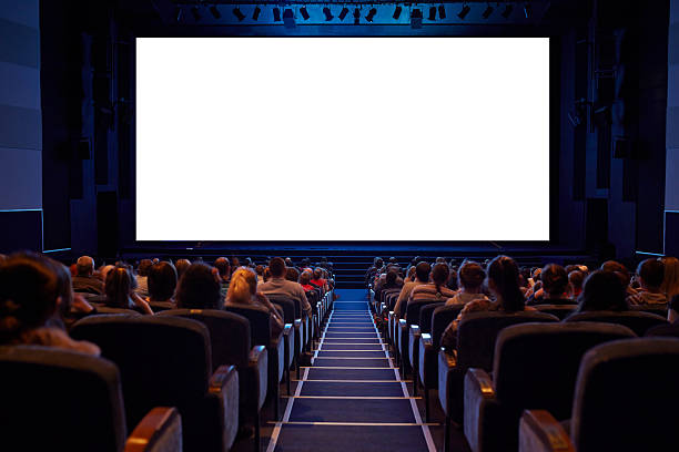Empty cinema screen with audience. Empty cinema screen with audience. Ready for adding your picture. Screen has crisp borders. This shot was made using tripod with long exposure. movie theater photos stock pictures, royalty-free photos & images