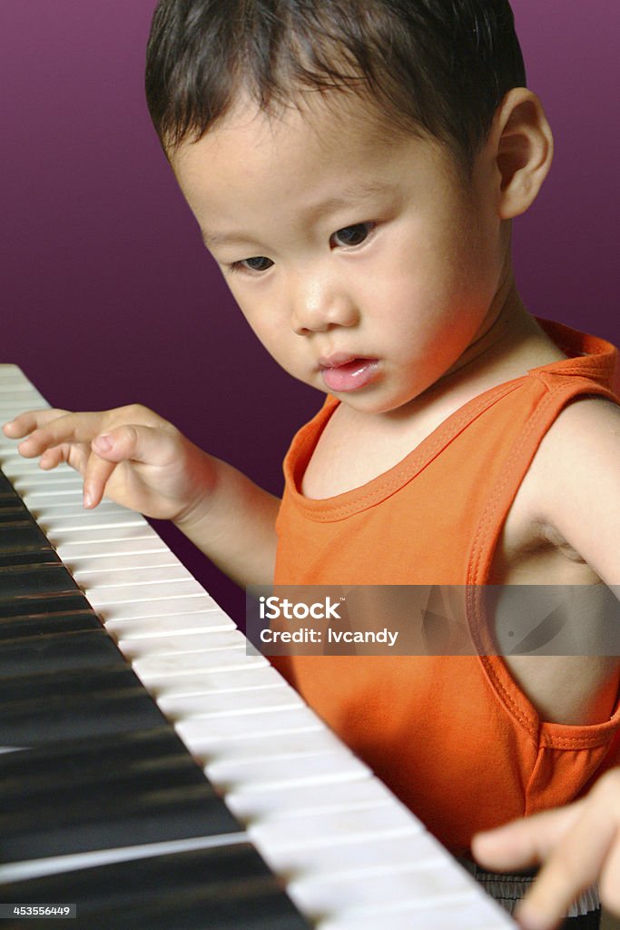 Boy playing the piano 2-3 Years Stock Photo