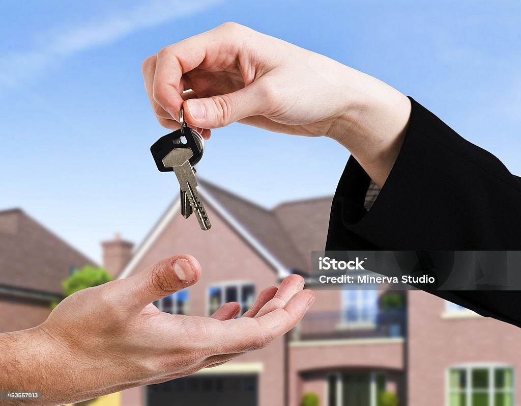 Keys Hand passing a set of keys to another hand Adult Stock Photo