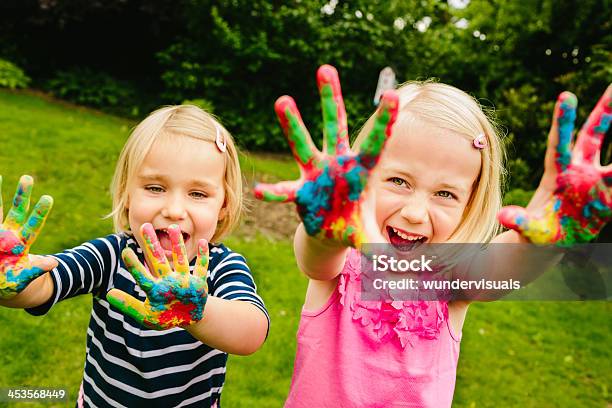 Cute Sisters Having Fun With Finger Paint Stock Photo - Download Image Now - Child, Painting - Activity, Finger Painting