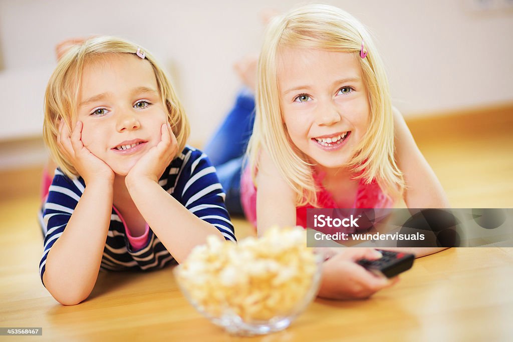 Sisters having fun watching tv Girl in front of television 2-3 Years Stock Photo