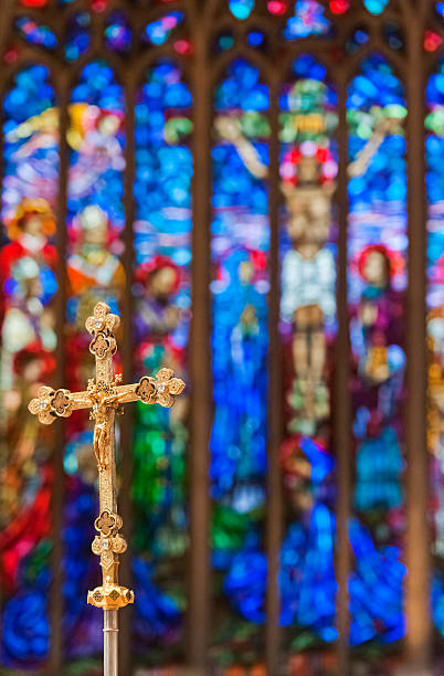 istock Crucifix in front of a stained glass window 453568757