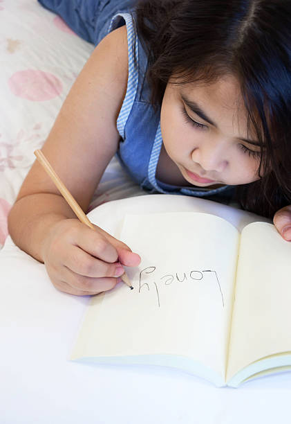 istock Little girl writing words that 