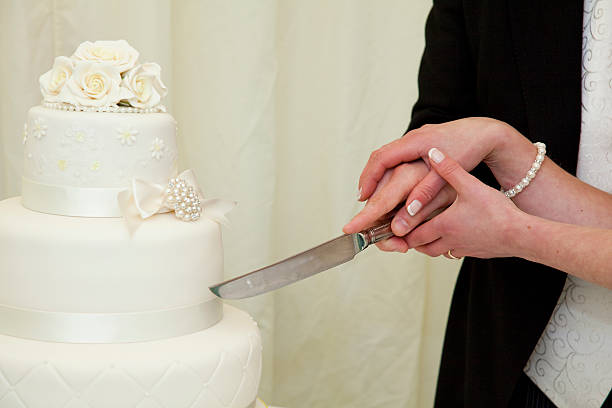 Wedding Cake being cut by the bride and groom