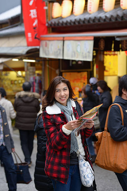 istock smiling woman tourist hold map 453573847