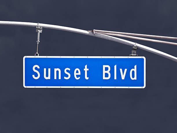 istock Sunset Blvd Overhead Street Sign with Dark Storm Sky 453576467