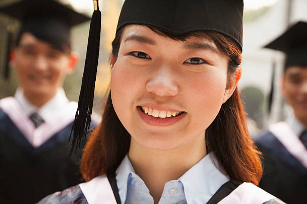 istock Young Graduates in Cap and Gown 453577365