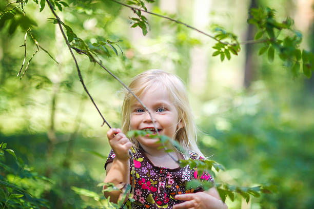 istock Little cheerful girl in the forest 453580473