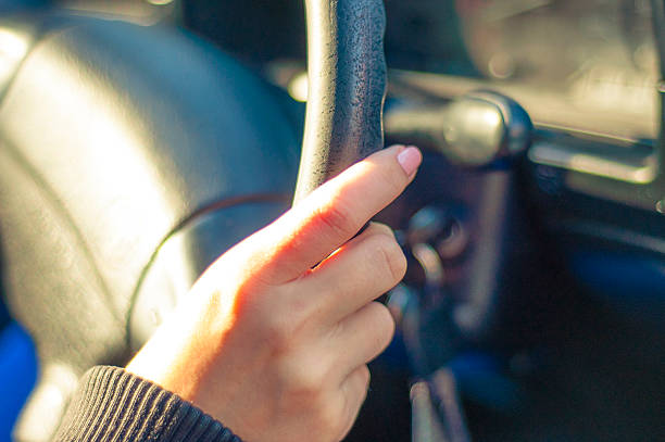 istock Female hand on steering wheel 453594943