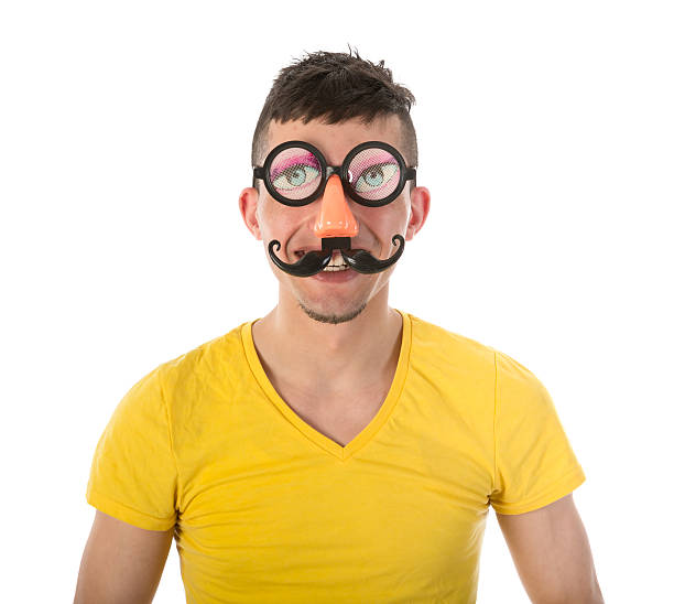 istock Man with funny carnival mask isolated over white 453596321