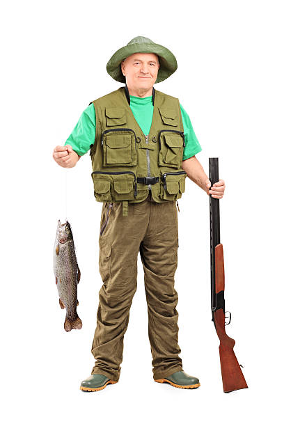 mature-hunter-with-shotgun-holding-a-fish.jpg