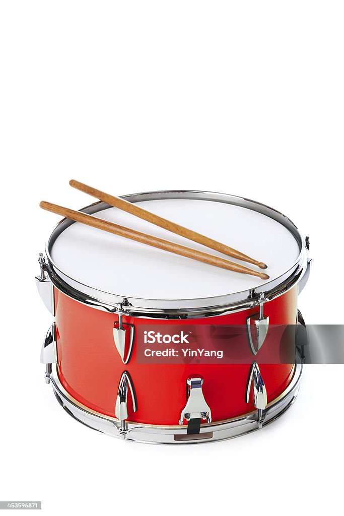 Red Snare Drum with Sticks Isolated on White Background Subject: A red drum with drum sticks isolated on a white background. Drum - Percussion Instrument Stock Photo