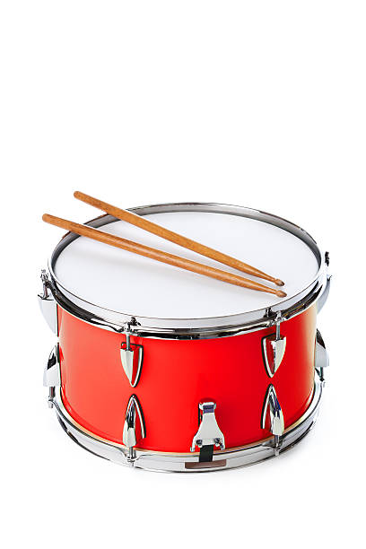 Red Snare Drum with Sticks Isolated on White Background Subject: A red drum with drum sticks isolated on a white background. snare drum photos stock pictures, royalty-free photos & images