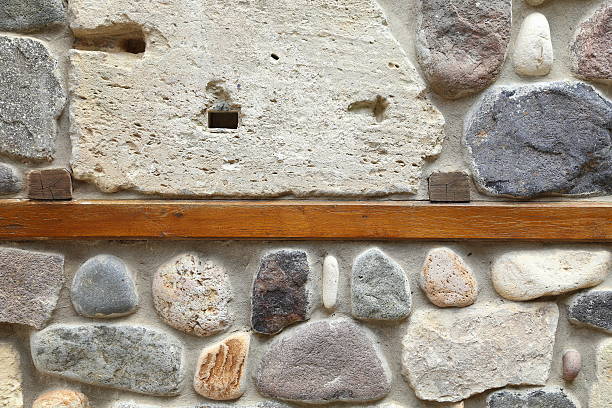 istock wooden board concreted into a stone wall 453602723