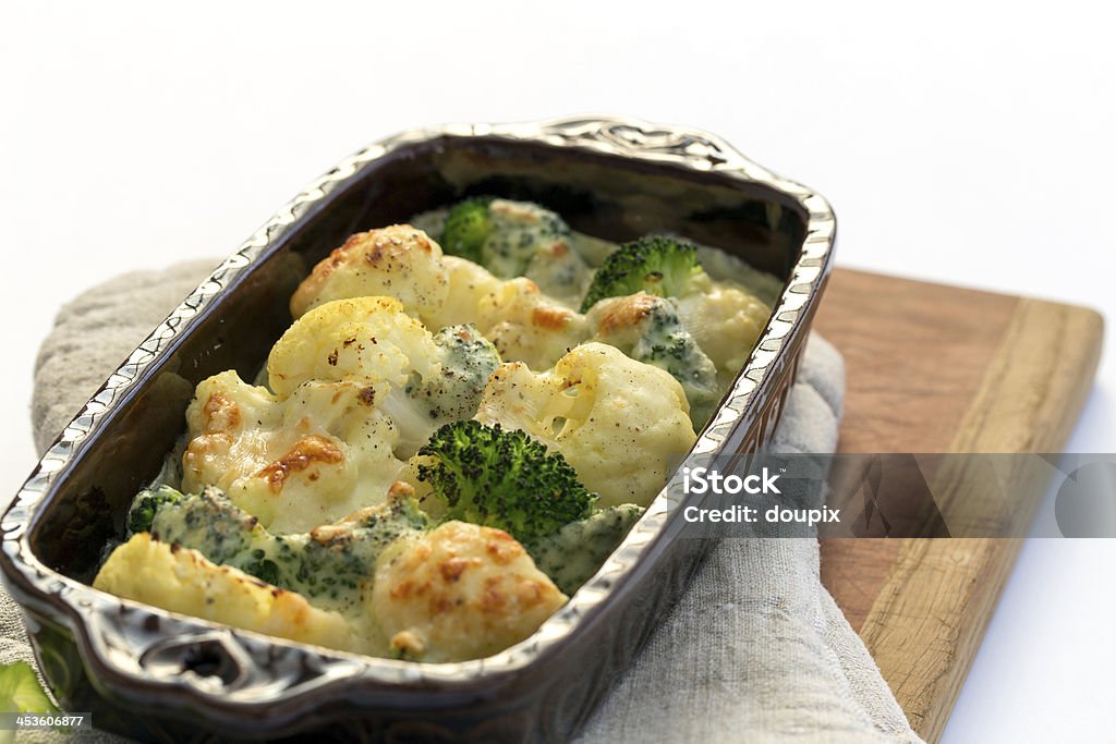 Gratin of cauliflower, broccoli and cheese Gratin of cauliflower, broccoli and cheese in brown rustic dish. Baked Stock Photo