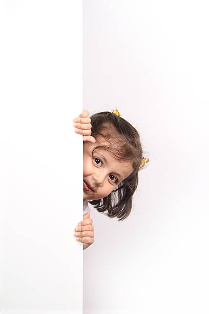 istock Little girl looking behind to board 453610163