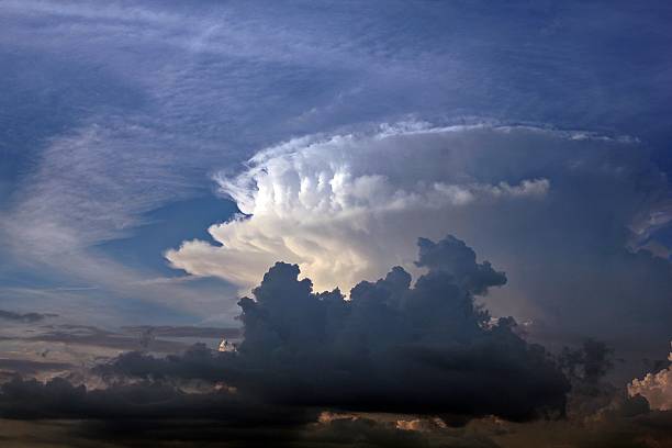 istock Black and white storm clouds against the blue sky 453616699