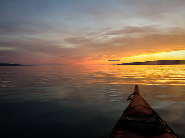 istock Kayaker pauses to look at glowing Alaskan sunset 453616931