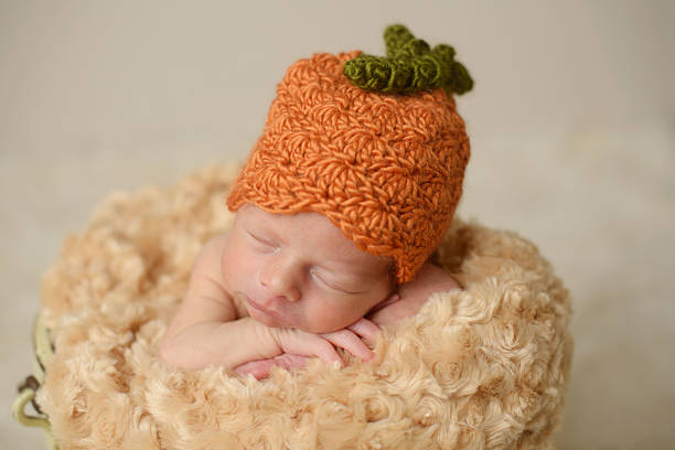 istock Close Up of Newborn Sleeping in a Knit Hat 453619163