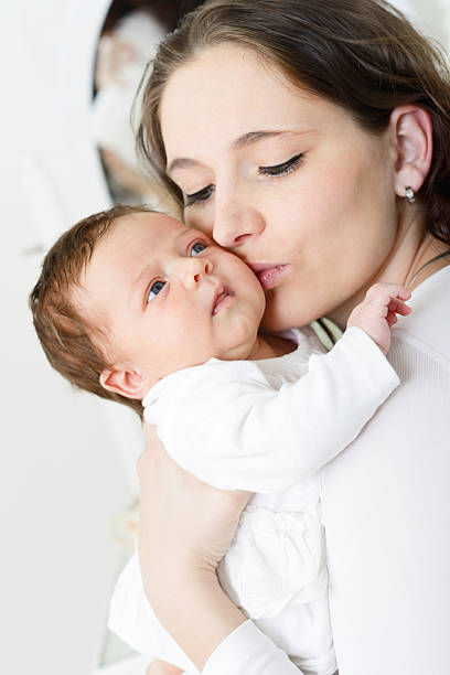 istock Mother kissing her baby 453632905