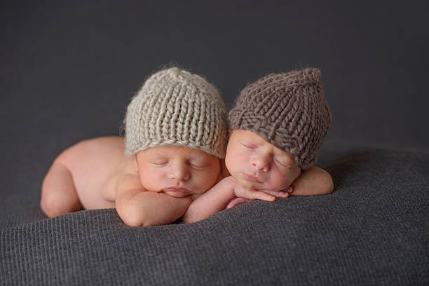 istock Newborn Twins Sleeping in Knit Hats 453633315