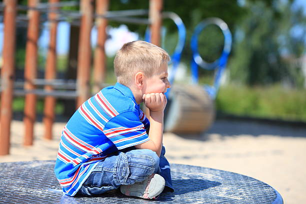 istock thoughtful child boy or kid on playground 453650241
