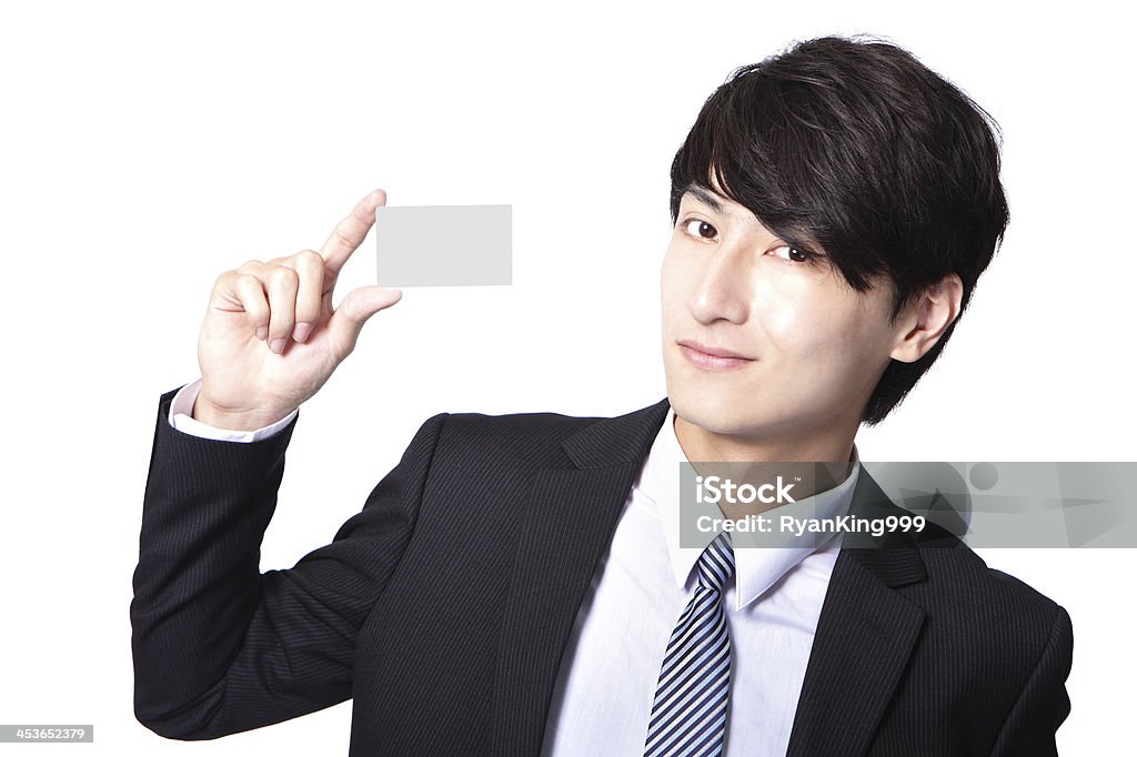 business card in man hand business card in business man hand with smile face ( focus on paper ) isolated on white , asian Adult Stock Photo