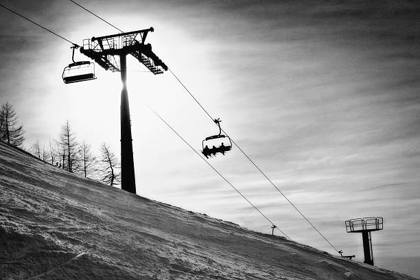 Chair Lift Three skiers riding a chairlift.Krvavec,Slovenija;Europe krvavec stock pictures, royalty-free photos & images