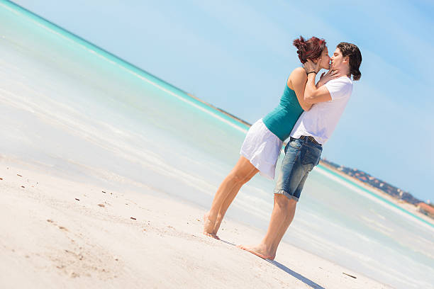 istock Young Couple Embraced in a Caribbean Beach 453657905